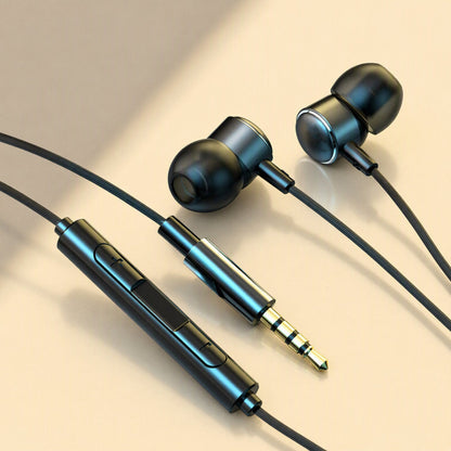 Earchime Type-C wired in-ear headphones in black with inline remote and gold 3.5mm plug on a beige surface