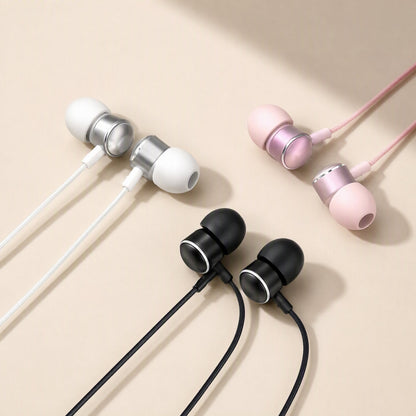 Earchime – White, rose pink and black wired in-ear headphones with metal-ringed earbuds arranged on a beige backdrop