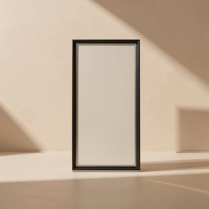 Casebolt – Empty black-framed rectangular panel standing upright on a beige floor in angled sunlight
