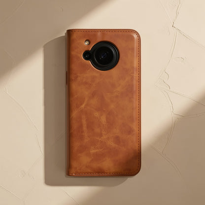 Softshell – Tan leather flip case lying flat, showing mottled calf texture, stitched edges and round camera opening