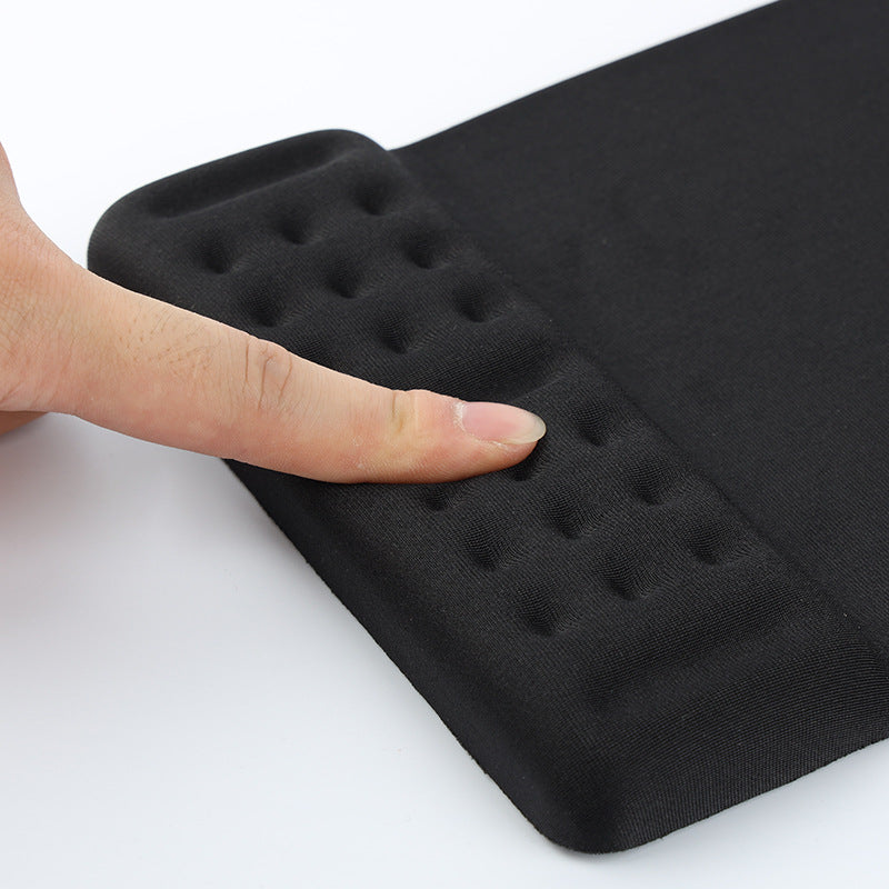 Restfoam Memory Foam Wrist Rest Pad – finger pressing the dotted, textured surface of a black wrist rest pad