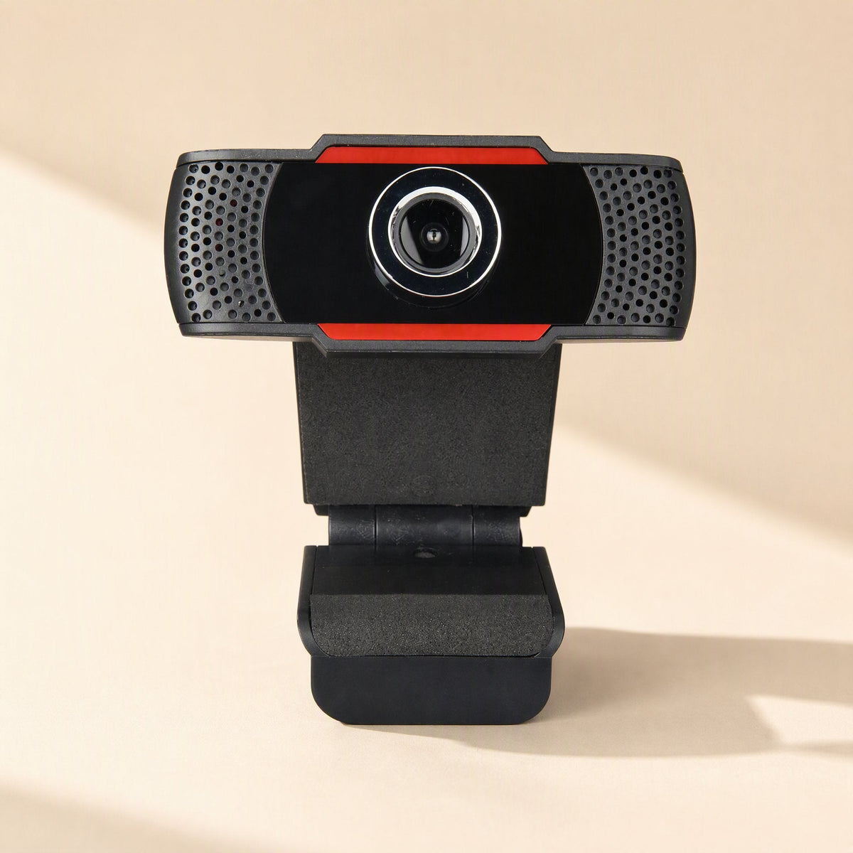 Sharpview – Front view of the webcam with red trim, perforated microphone grilles on both sides and foldable clip base