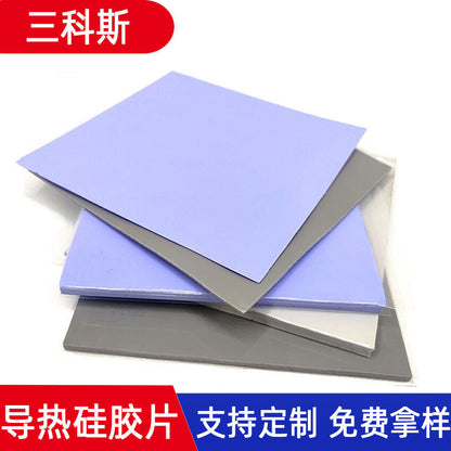Dewflex Silicone Thermal Pad sheets in blue-purple and gray stacked at angles, with Chinese text banners
