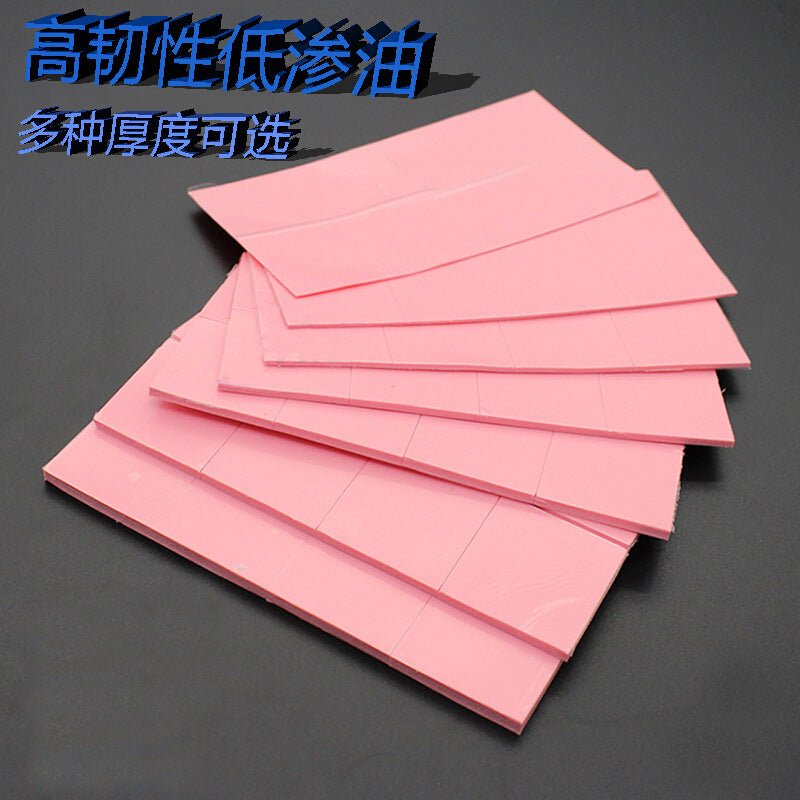 Dewflex – Stack of pink thermal pad sheets fanned out on a dark surface, each scored into small rectangular pieces