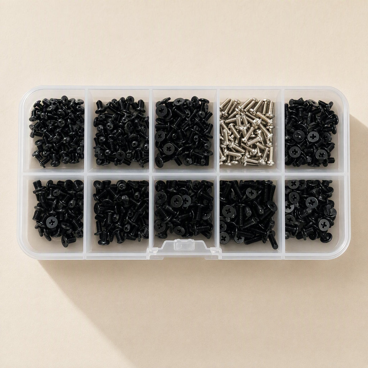 Screwstack Laptop Screw Set in a clear 10-compartment box, top view, nine black and one silver screw section