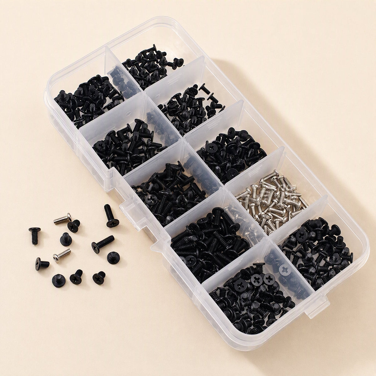 Screwstack – Angled view of the open organizer box with sorted black and silver screws and loose screws beside it