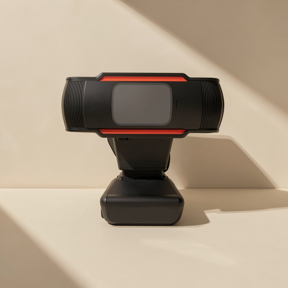 Talklens – Rear view of the webcam head with orange trim, tilted on its black stand in warm sunlight