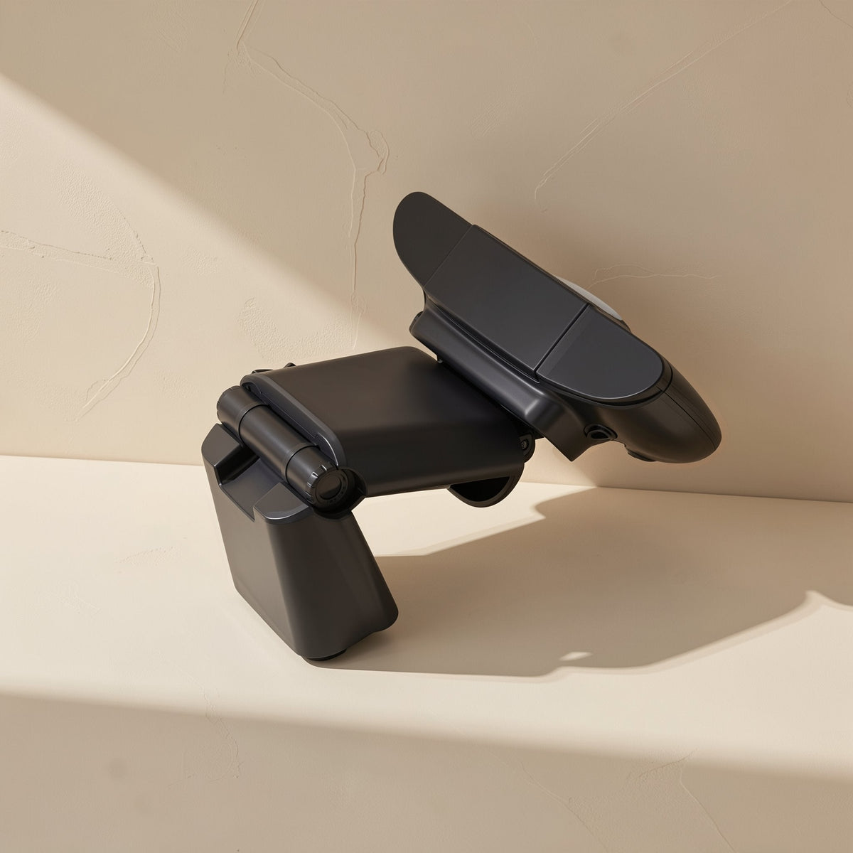 Talklens – Webcam folded and tilted at an angle on its hinged stand, showing the joint, against a textured wall
