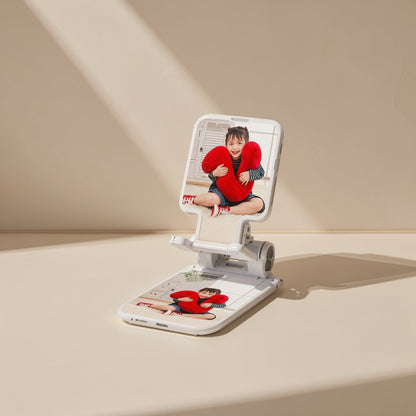 Foldperch – White phone stand with a child holding a red heart pillow shown on the screen and the base panel