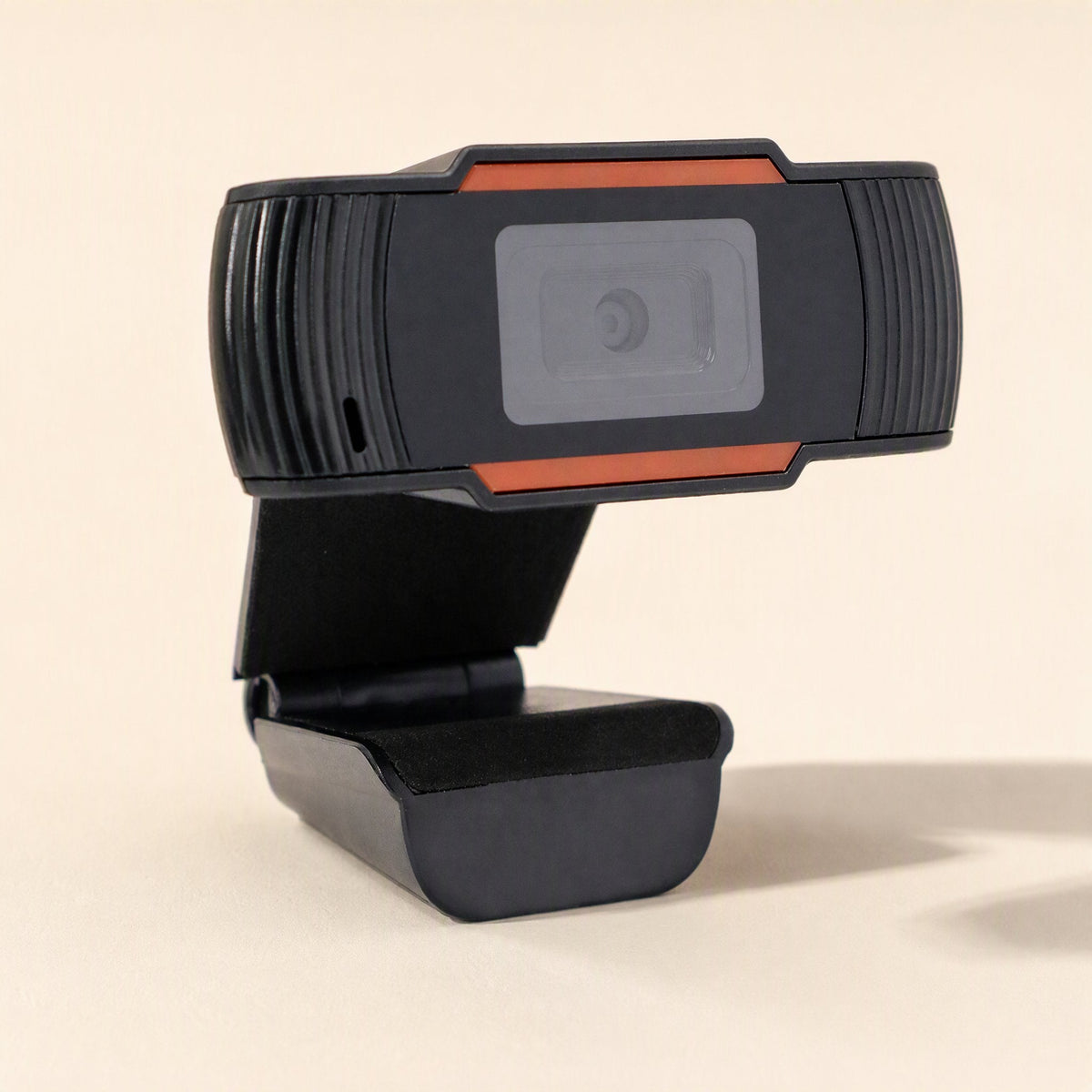 Clearcam – Three-quarter view showing the camera's ribbed side, small microphone hole and folded clip base