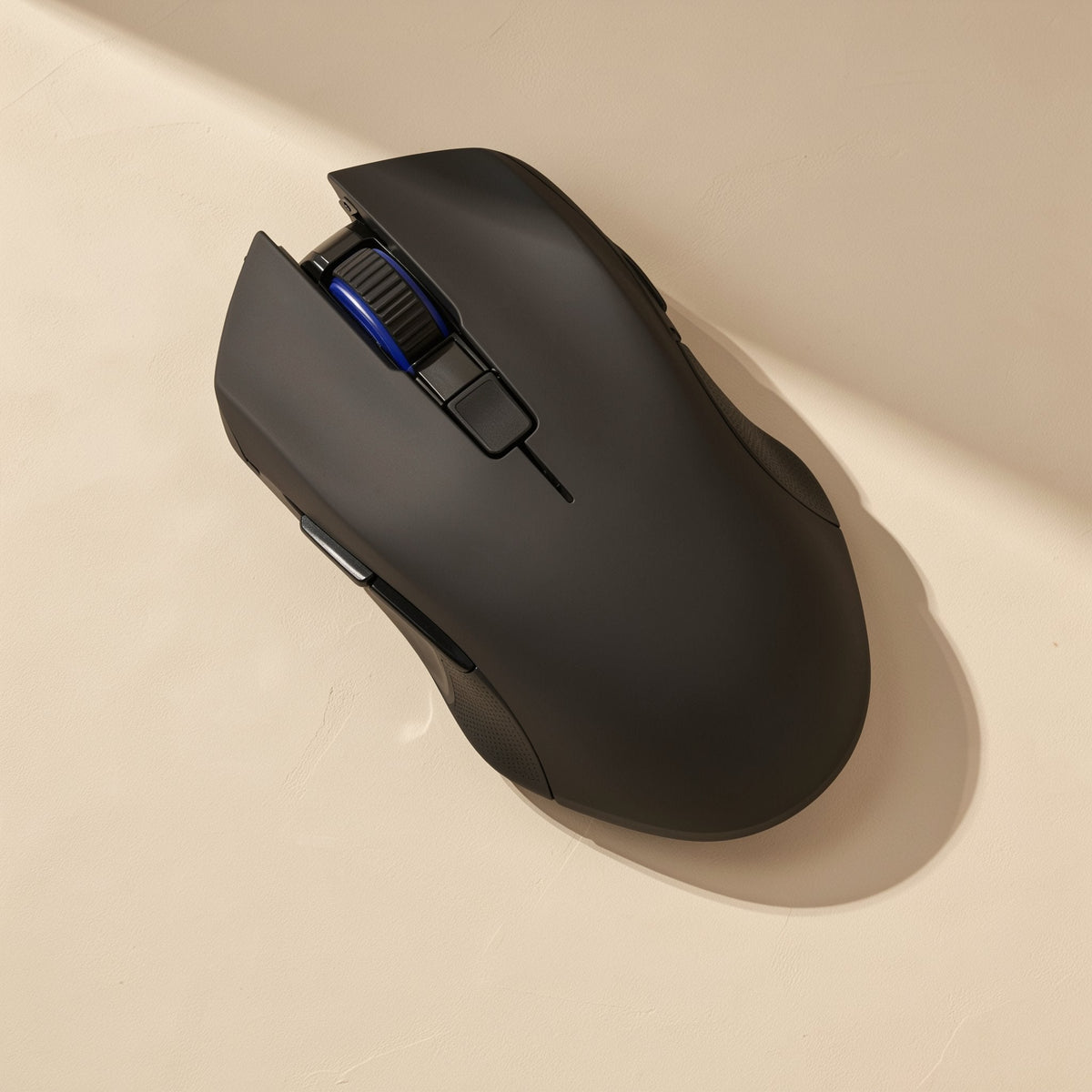 Clickglide – Black wireless mouse from above, showing scroll wheel with blue accent and side buttons