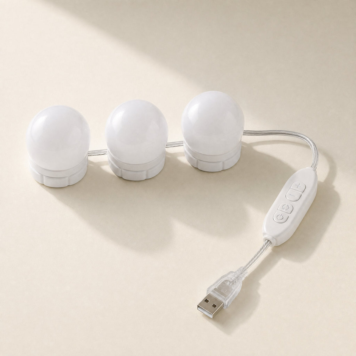 Deskbeam – Three white round vanity-style bulbs on a clear USB cable with a touch control switch
