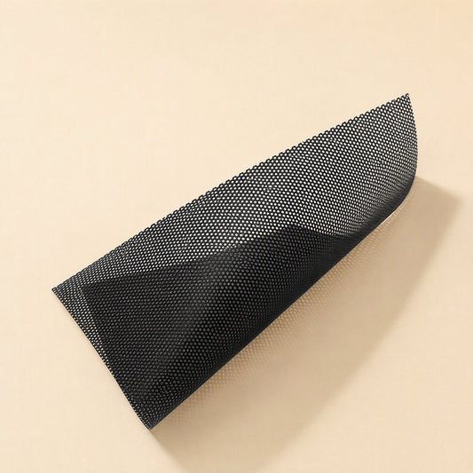 Airmesh PVC Chassis Fan Dust Mesh – black perforated PVC dust mesh sheet curled at one corner on a cream surface