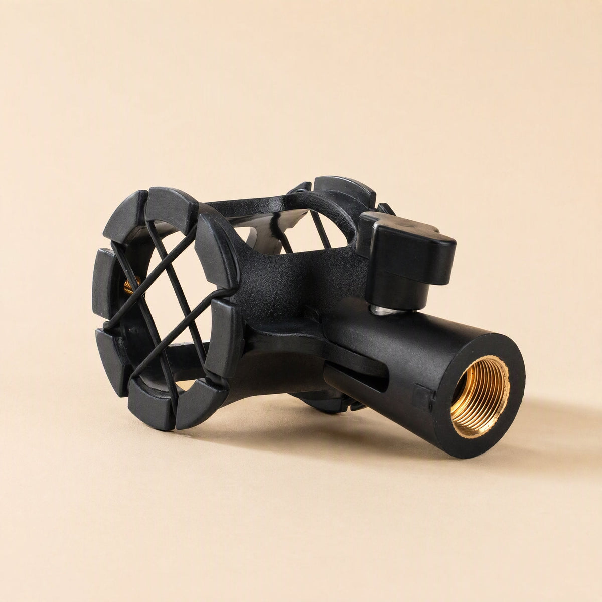 Miccushion – Black shock mount lying on its side showing the brass threaded socket at the base