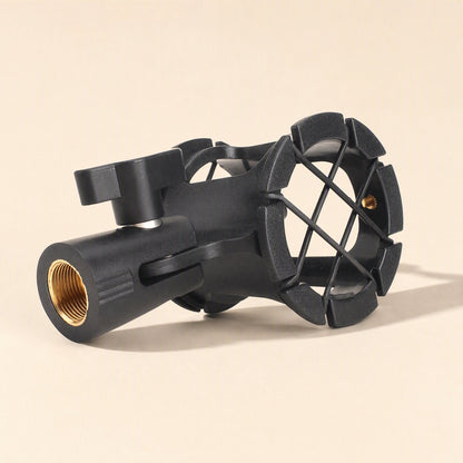 Miccushion – Side view of the shock mount with brass threaded base and elastic cradle on a beige background
