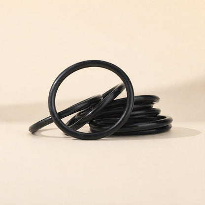 Miccushion Condenser Microphone Shock Mount Bracket – stack of black replacement elastic bands on a beige background