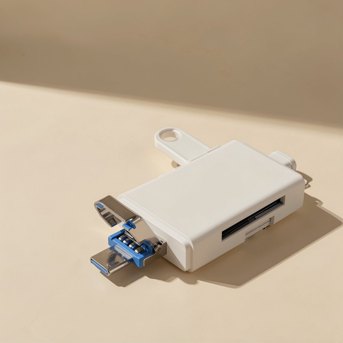 Sixport – White card reader on a beige surface with a flip-out blue USB connector and keyring loop