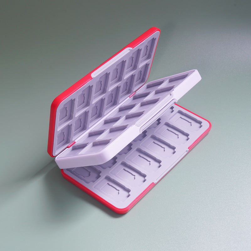 Tuckbox – Open lilac card box with red edges, showing the empty game and TF card slots from above at an angle