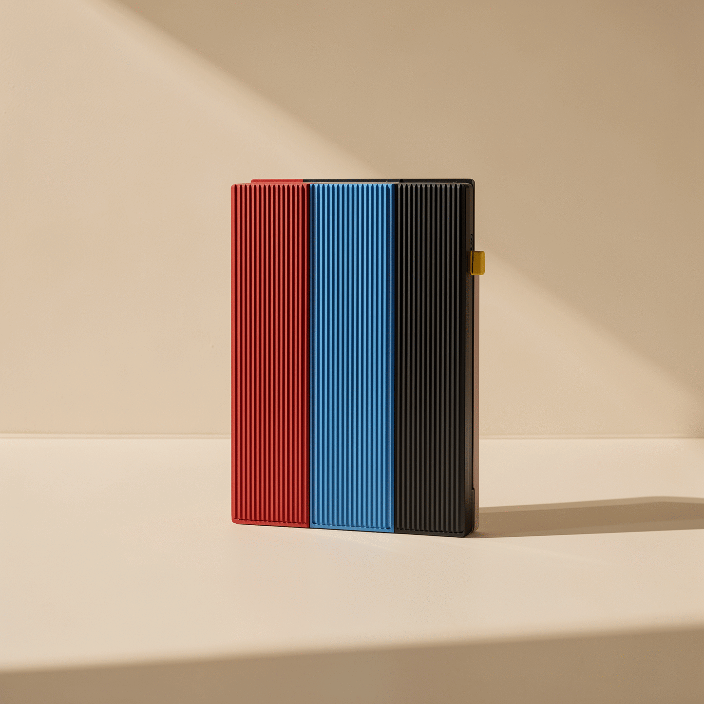 Swiftbyte Metal Portable Solid State Drive in red, blue and black ribbed finishes standing side by side