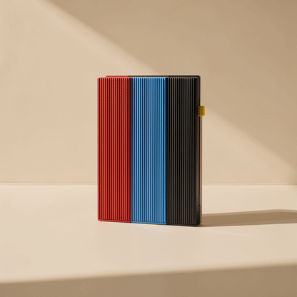 Swiftbyte Metal Portable Solid State Drive in red, blue and black ribbed finishes standing side by side