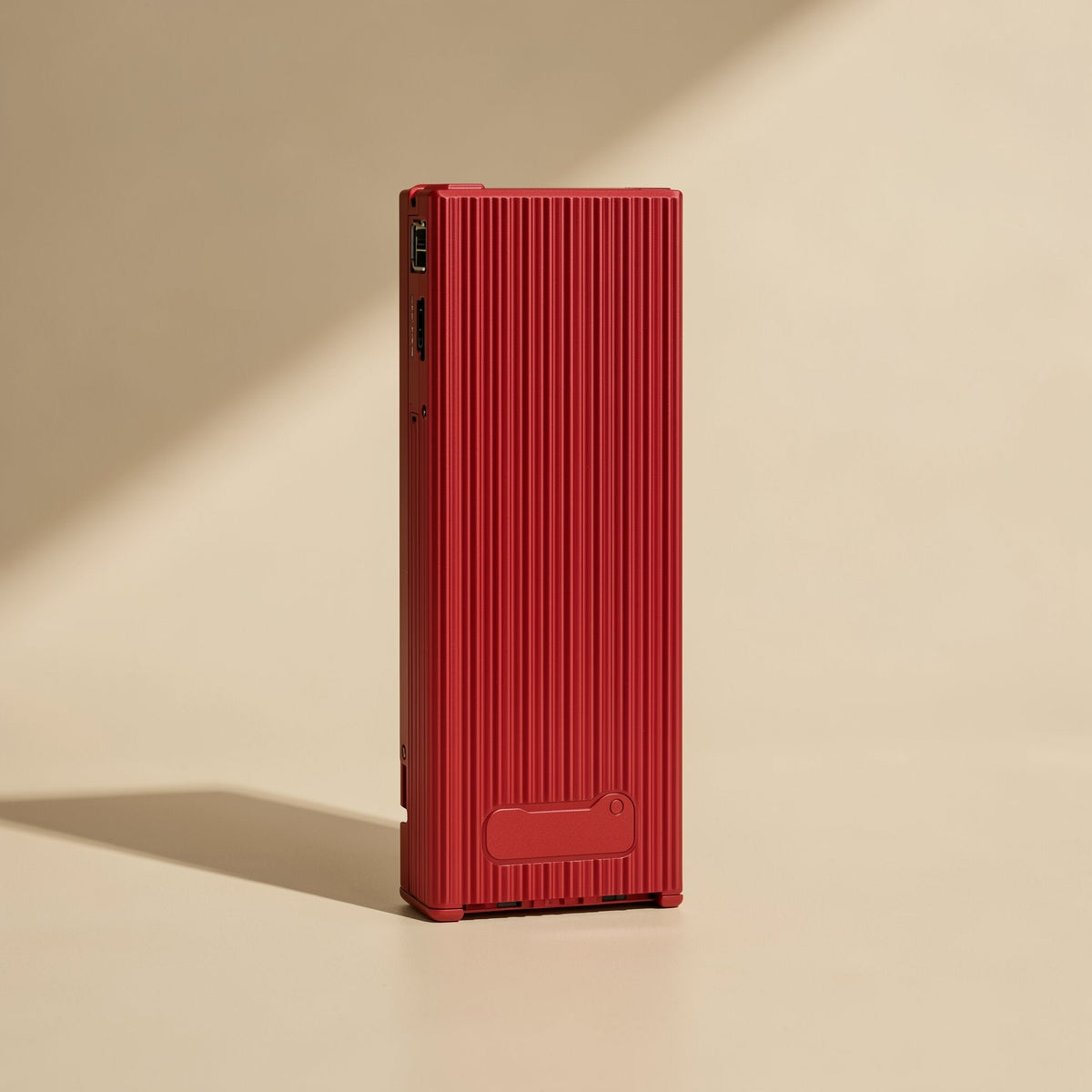 Swiftbyte – Red ribbed metal portable SSD standing upright, showing port openings at the top and a small tab at the base