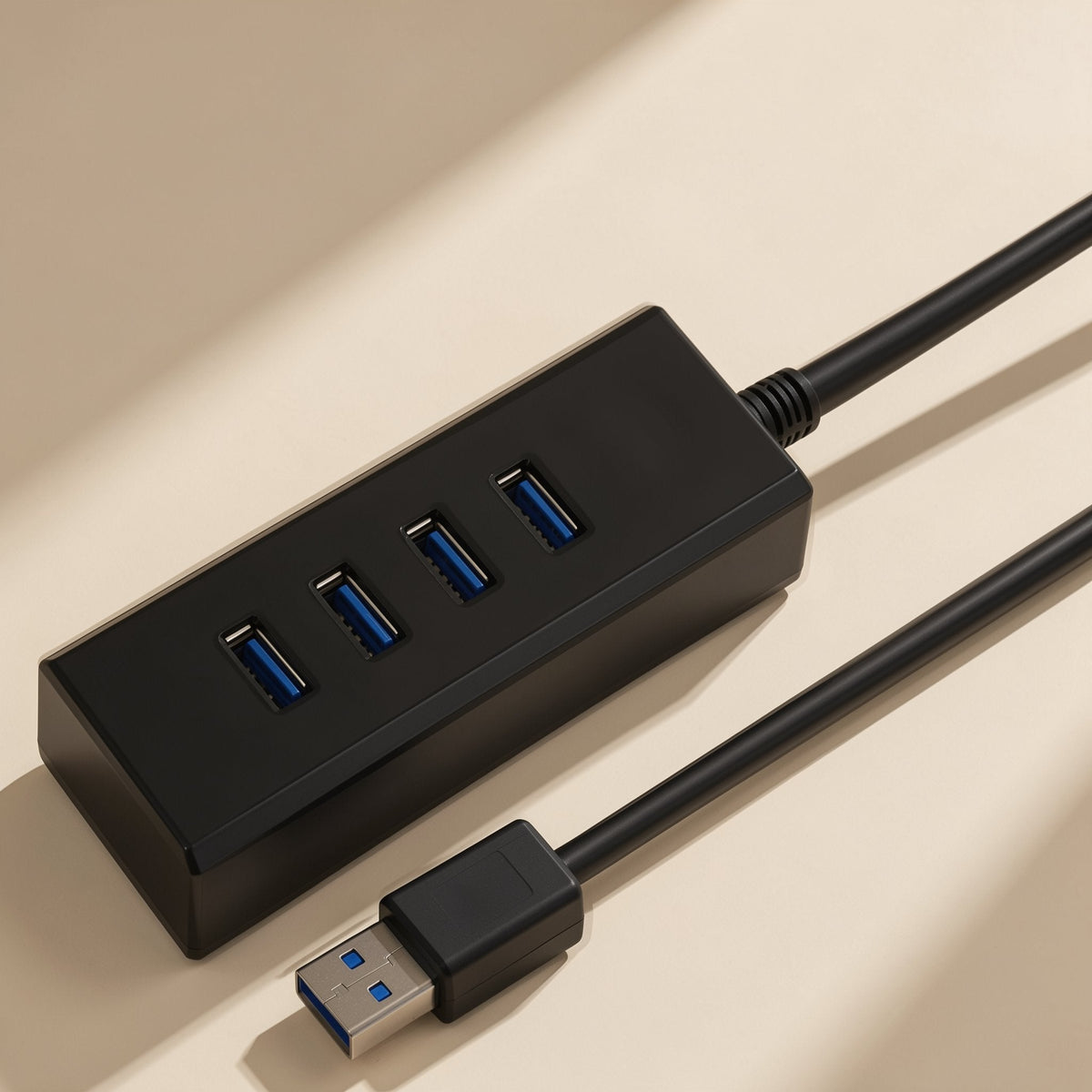 Portsplit – Black four-port hub seen from above, showing four blue-tipped USB ports and the attached cable and plug