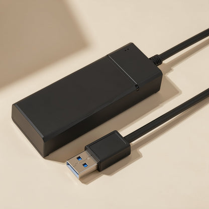 Portsplit – Black hub with a seam across one end, shown from above with the USB plug in the foreground on a cream backdrop