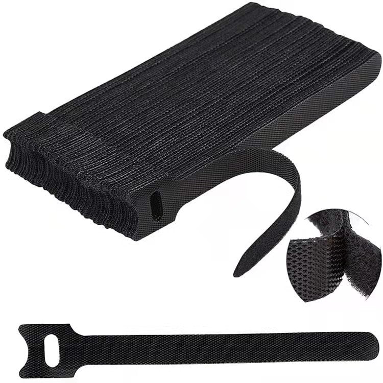 Catstrap – Black T-shaped straps stacked in a pile with a close-up of the hook and loop surface and one strap below