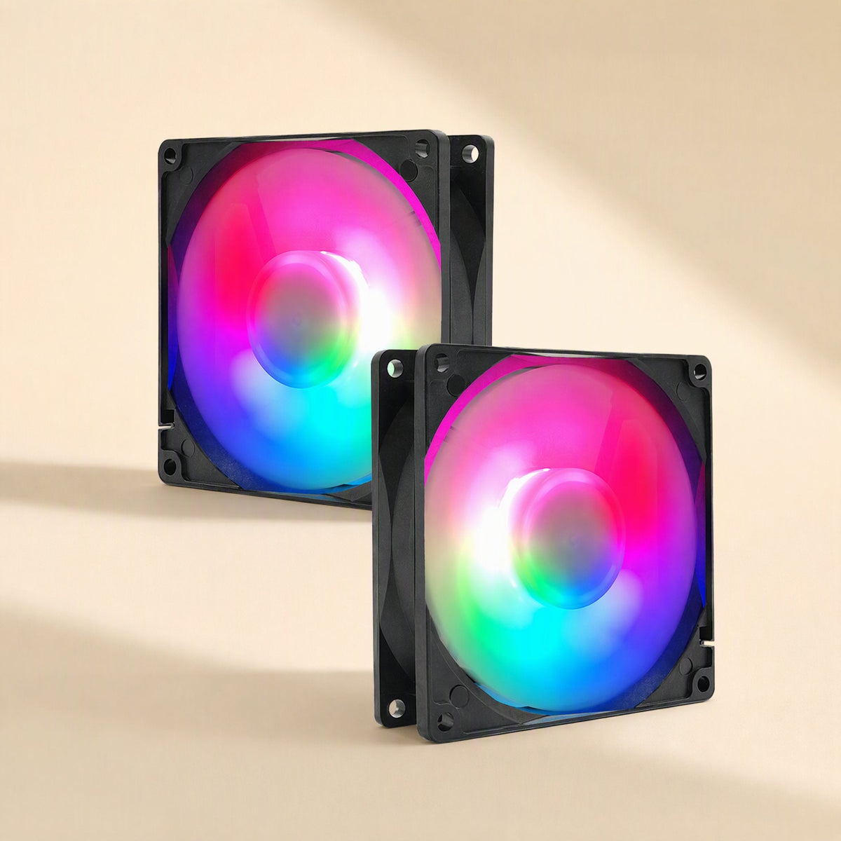 Copperchill – Two black square RGB fans glowing in pink, blue and green, shown side by side on a beige background
