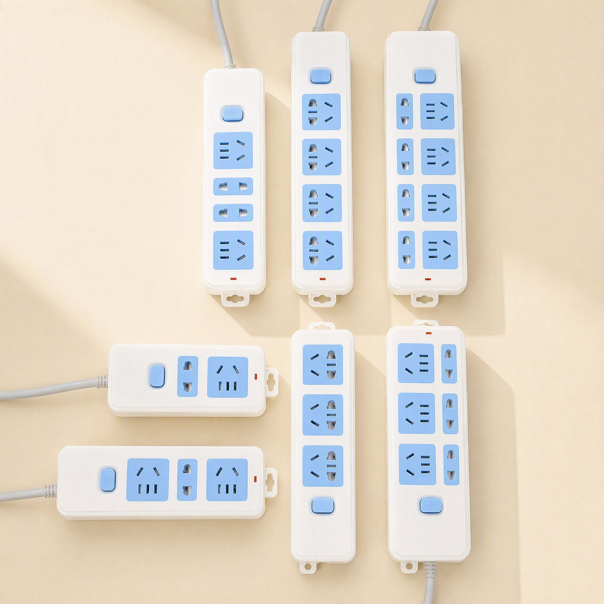 Cordcraft Office Computer Power Strip with Cord in white and blue, six strips laid out on a cream background
