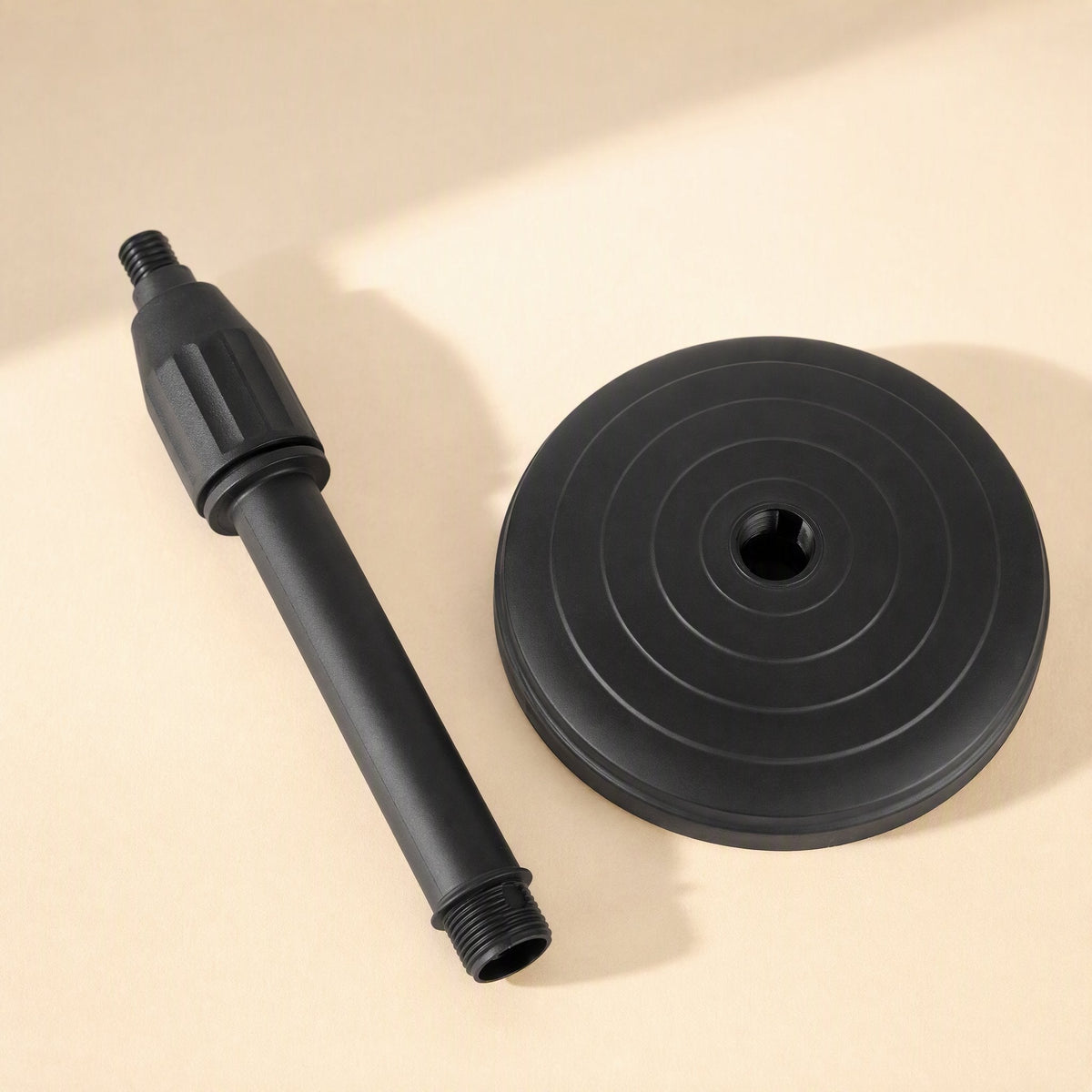 Voicelift – Disassembled stand showing the threaded telescopic rod beside the black ringed round base