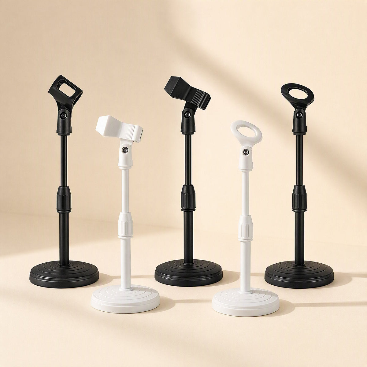Voicelift – Row of five desktop mic stands in black and white with oval and clamp clips, shown at a closer angle