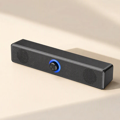 Clearbeat – Front view of black mesh-grille speaker bar with glowing blue ring around central knob