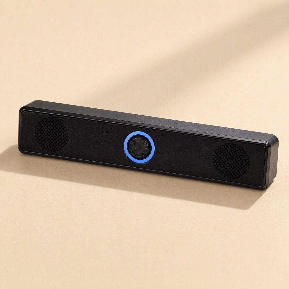 Clearbeat – Straight-on view of the speaker bar showing two round driver grilles and blue-lit center knob
