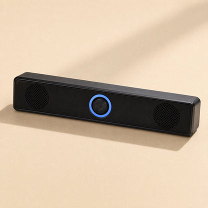 Clearbeat – Straight-on view of the speaker bar showing two round driver grilles and blue-lit center knob