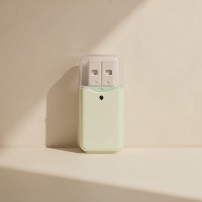 Flashport USB 2.0 TF Card Reader in mint green with clear cap over the USB plug, upright on a cream shelf