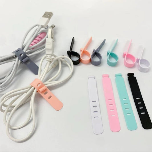 Cablehug – Cable straps holding coiled white USB cables, with looped straps in several colors and four flat straps below