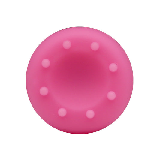 Joytread – Top view of a pink silicone joystick cap with a ring of raised grip dots around a concave centre