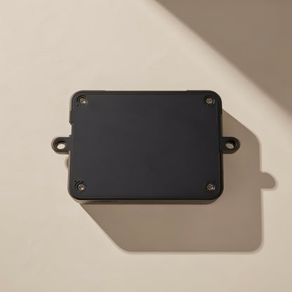 Workclick – Underside of black industrial mouse showing four corner screws and two mounting tabs on a cream background