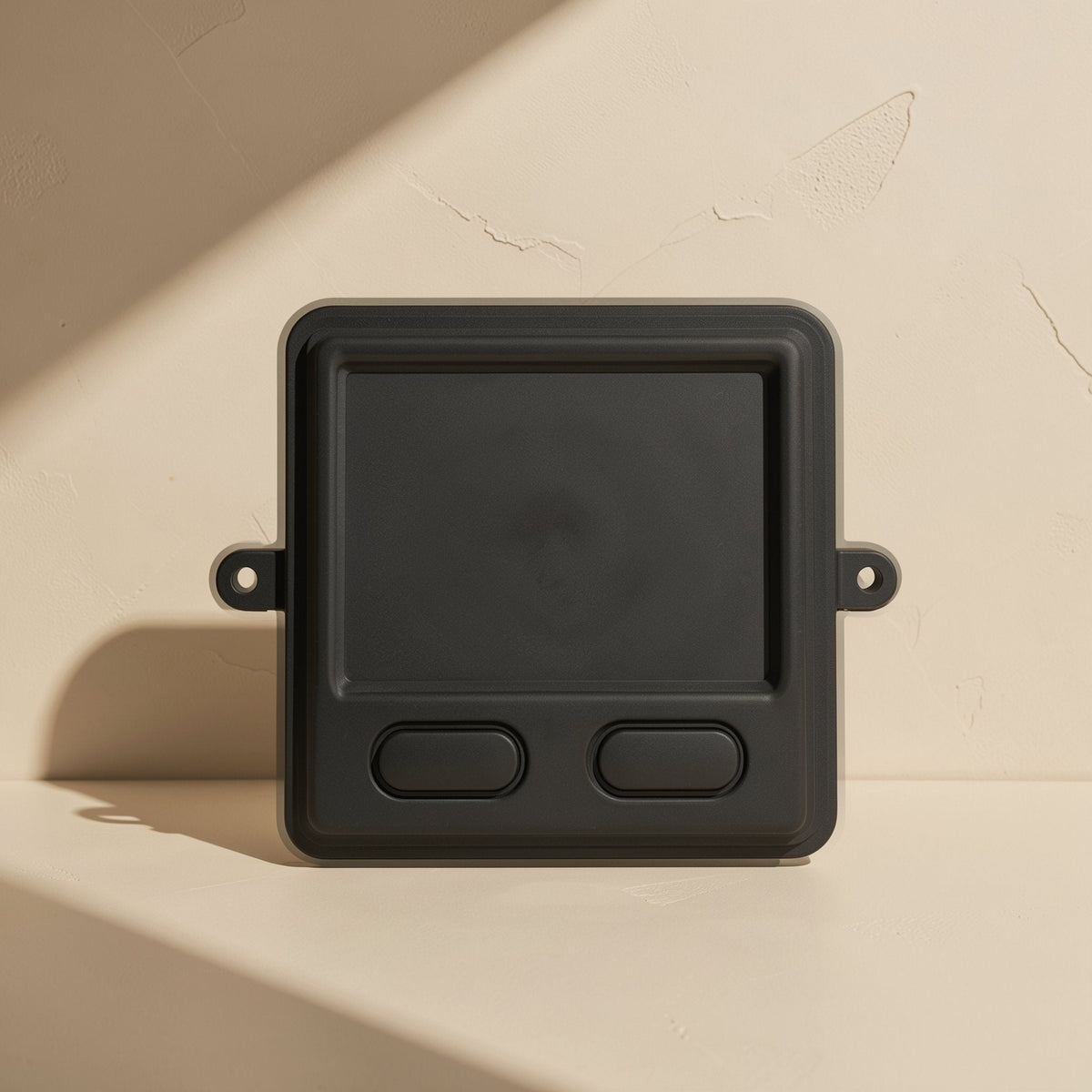 Workclick – Black industrial touchpad mouse standing upright against a textured beige wall, showing pad and two buttons