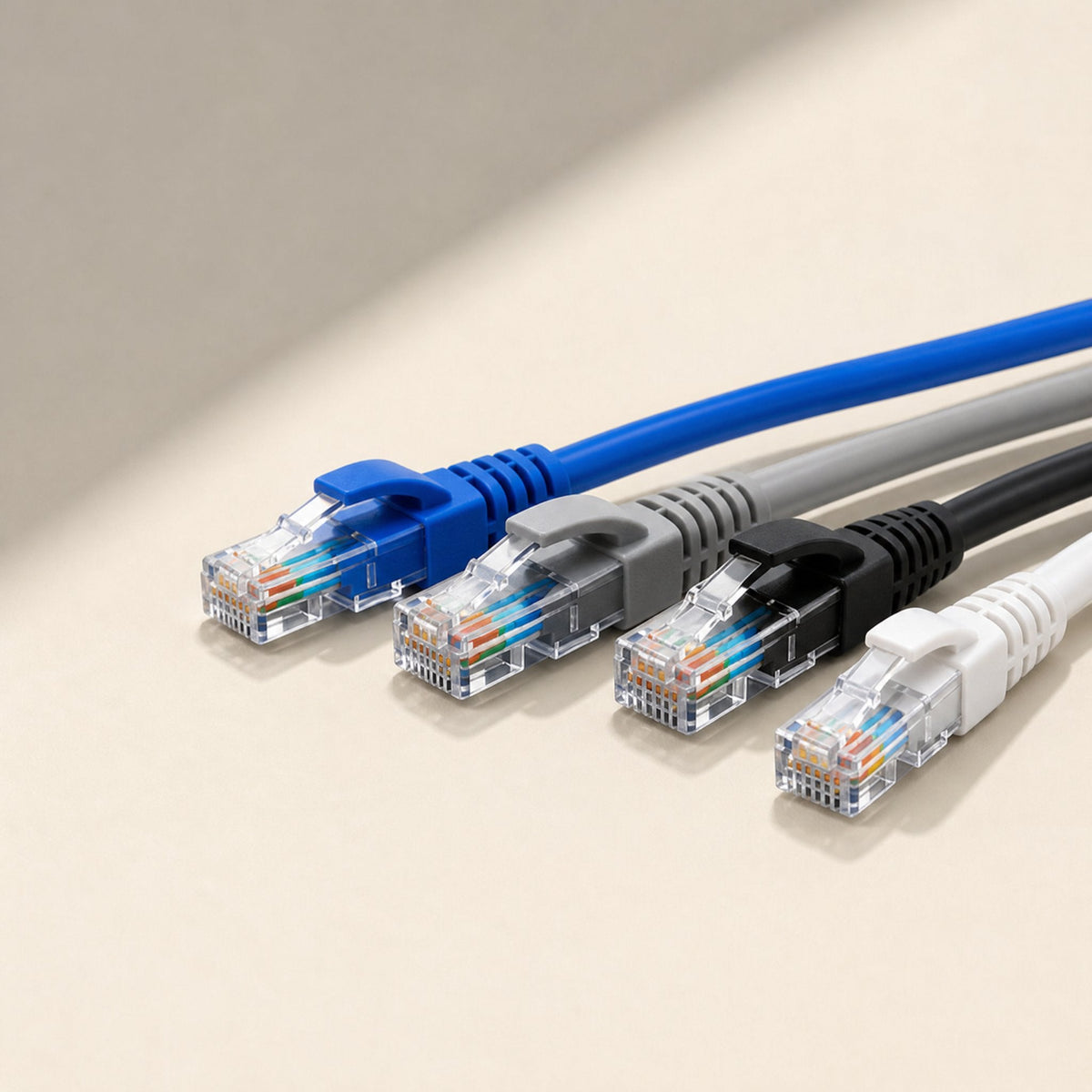 Linkpath CAT5e Network Cable – four network cables in blue, gray, black and white with clear RJ-45 plugs lined up at an angle