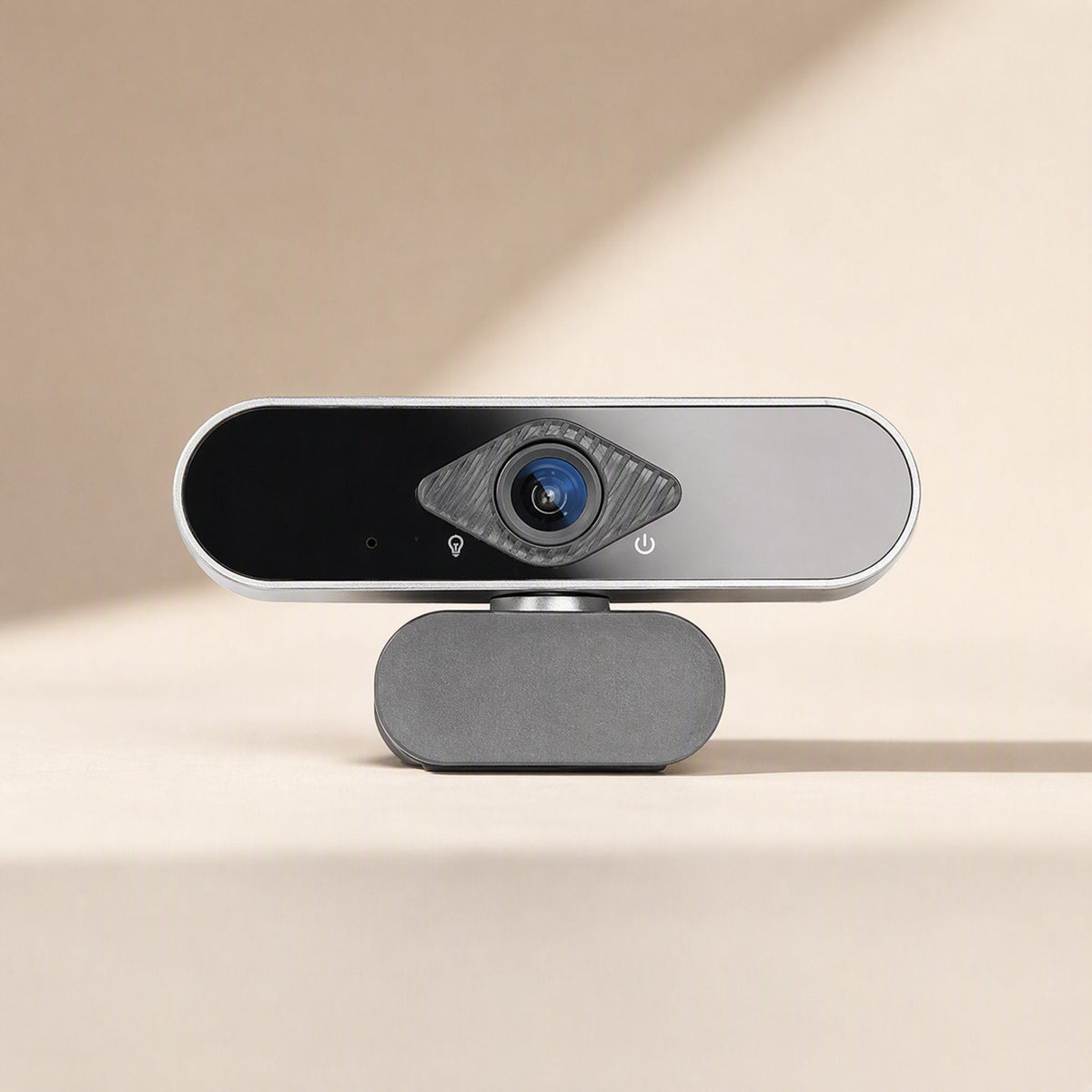 Faceview – Front view of the webcam with blue lens, diamond-shaped textured ring and grey fabric-covered base
