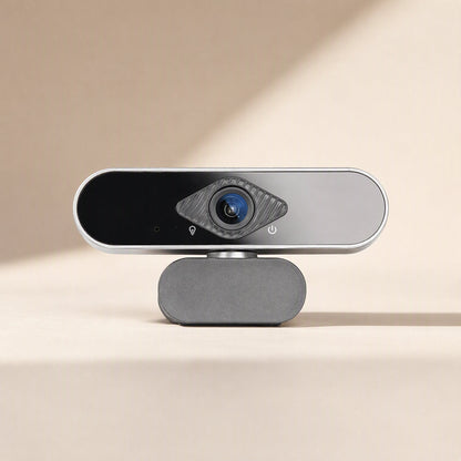 Faceview – Front view of the webcam with blue lens, diamond-shaped textured ring and grey fabric-covered base