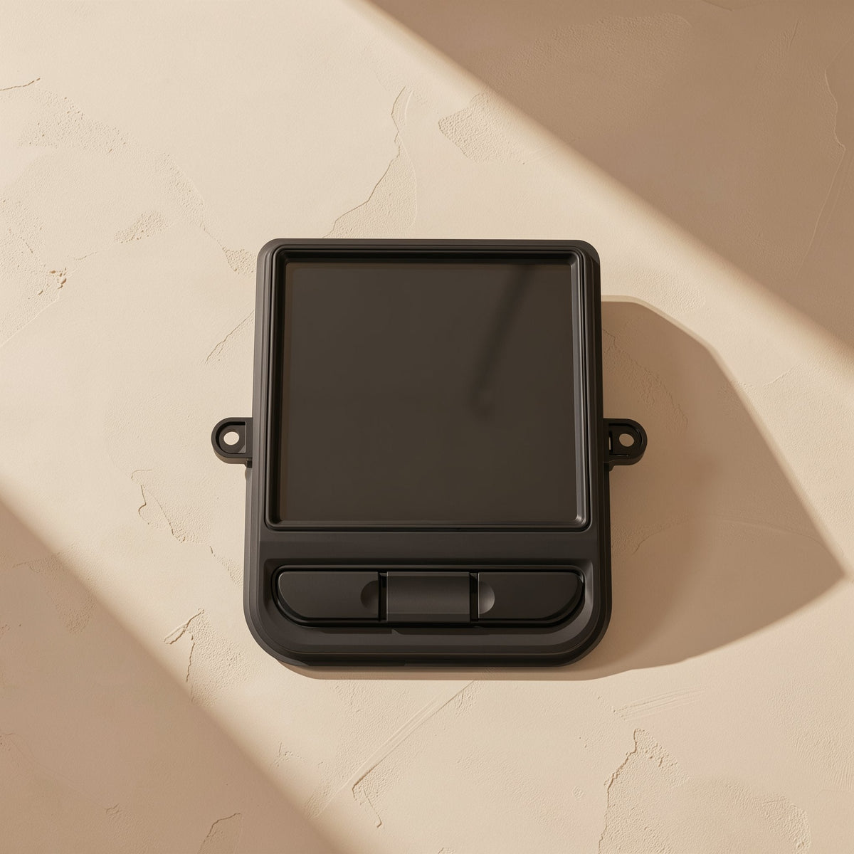 Twinorbit – Black trackball mouse seen from above with a square dark pad and three buttons, on a sunlit textured surface