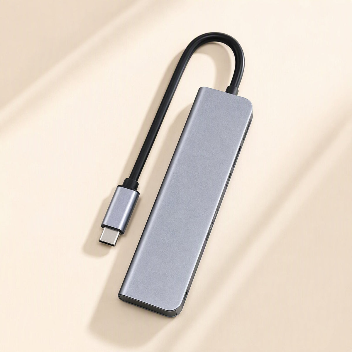 Dockarray – Top view of the grey aluminium docking station with its short black USB-C cable curved above it