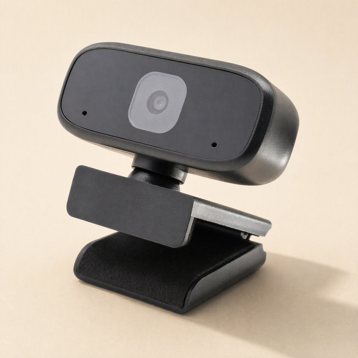Voiceview – Webcam's lens and two microphone holes shown from above on its folding clip base