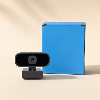 Voiceview – Black webcam standing beside a bright blue product box against a beige backdrop