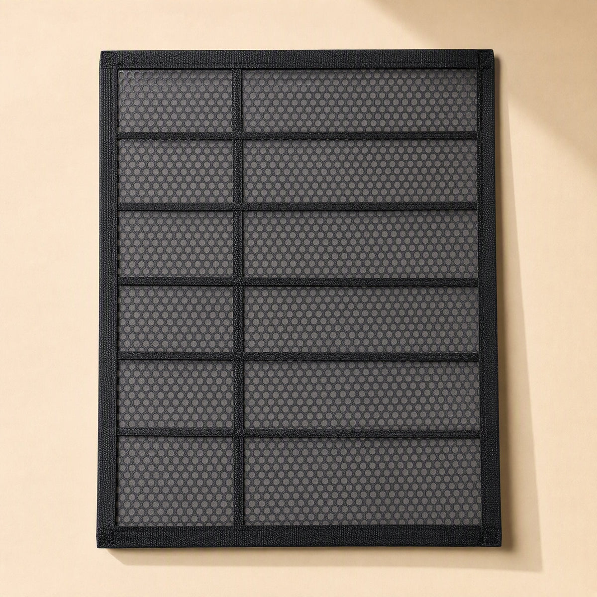 Dustveil – Black framed dust filter panel with a honeycomb mesh and horizontal bars, seen from the front