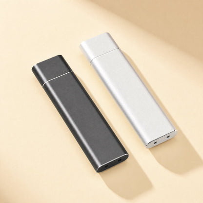 Alloydock M.2 SSD Enclosure in black and silver aluminum, shown side by side on a beige background