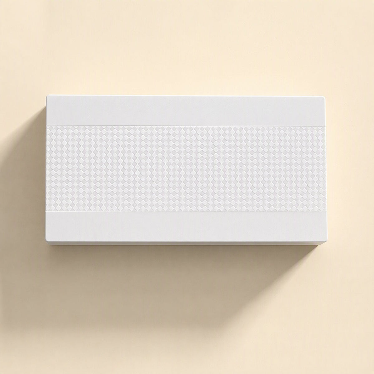 Deskport Desktop Network Switch – top view of white switch lid with a raised diamond-pattern band on a cream background